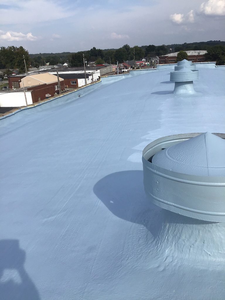 Flat commercial roof with a fresh protective coating on a building in Evansville, Indiana